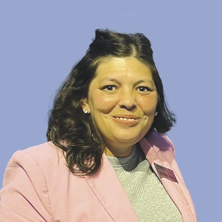 Woman in pink suit jacket