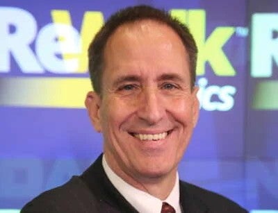 Headshot of smiling man in suit