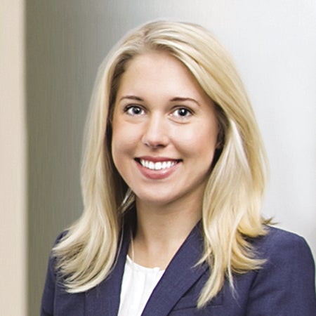 A woman in a suit jacket with blonde hair