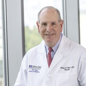 Man in lab coat and tie poses for portrait photo