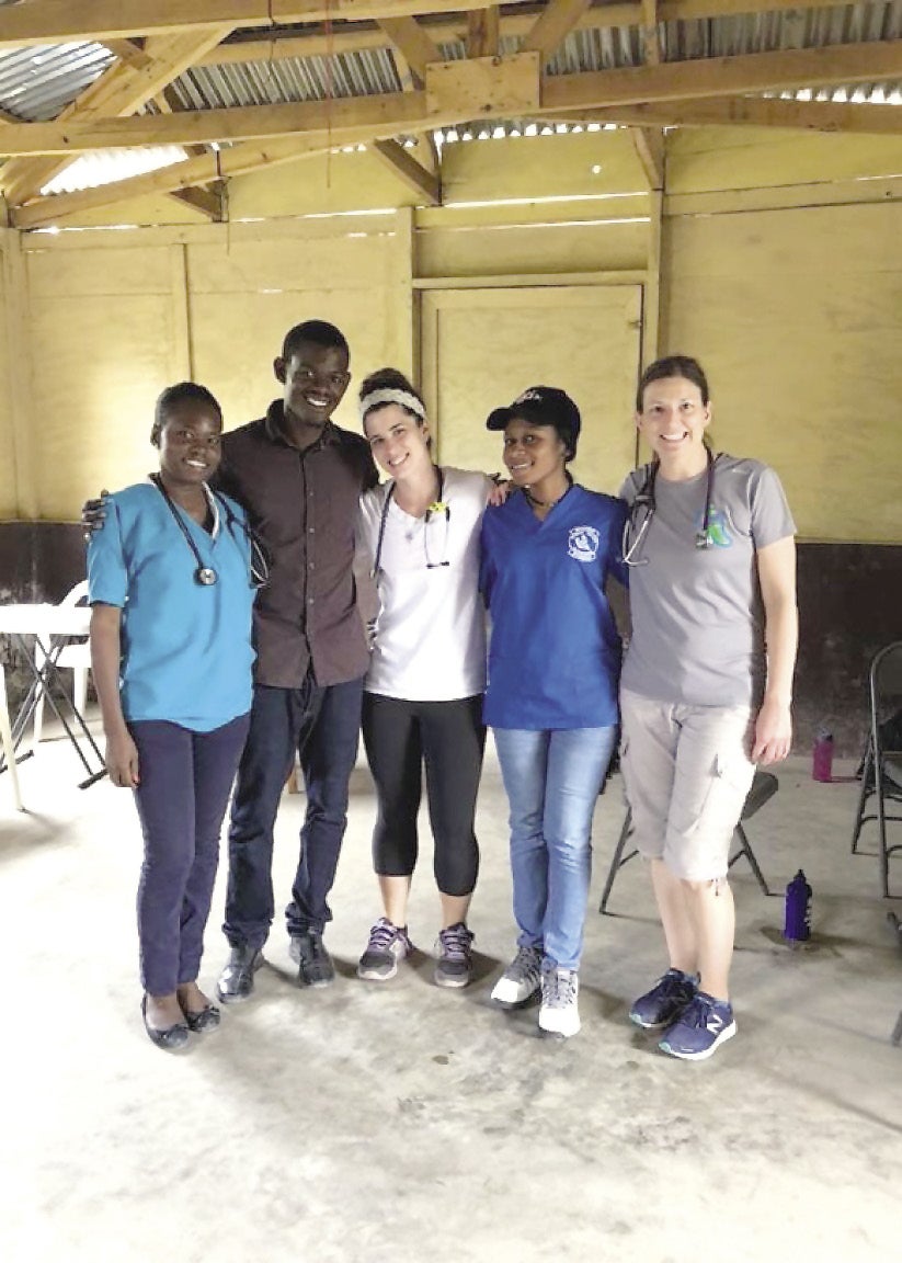 Five healthcare provides smile at the camera