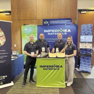 Four people stand at marketing booth