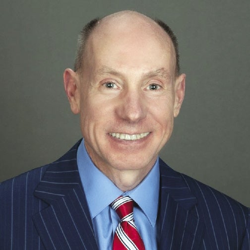 A smiling headshot of Joe Regan