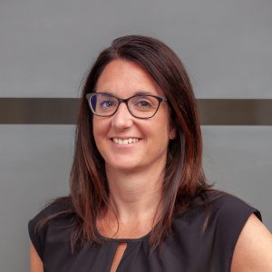 A woman with a glasses in a dress