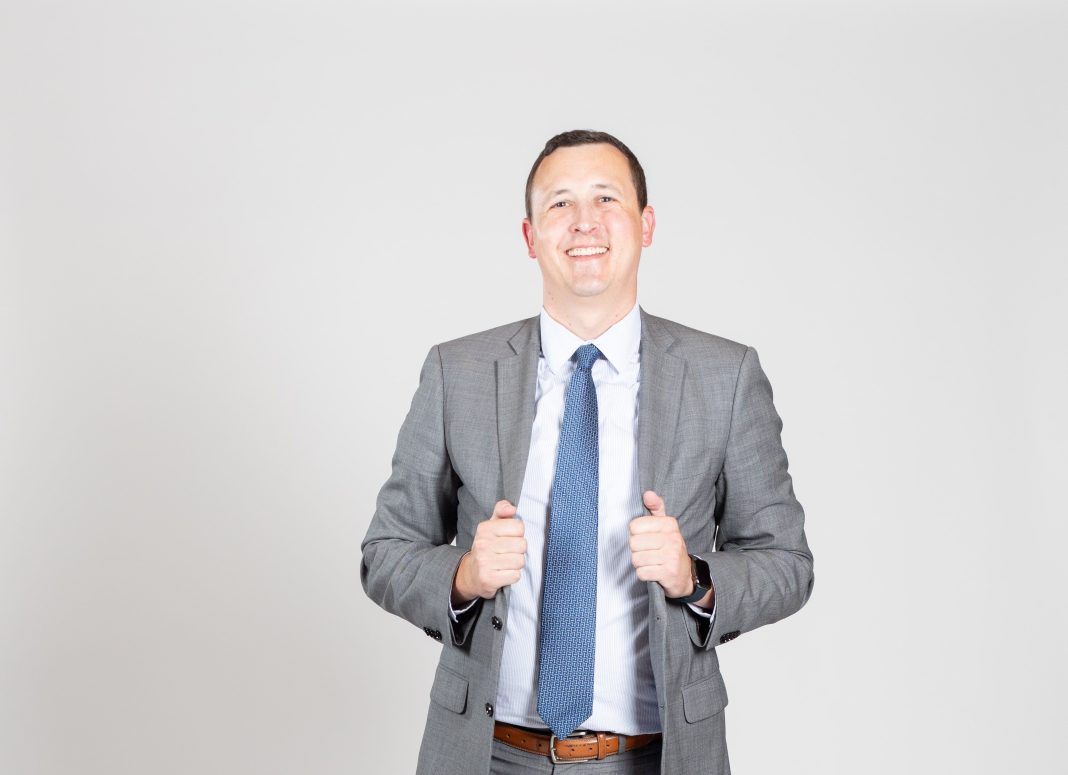Man in suit smiles