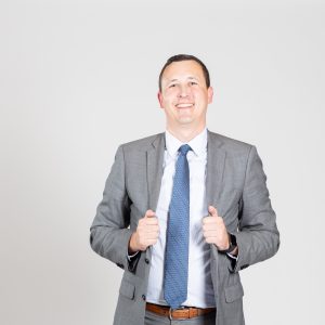 Man in suit smiles