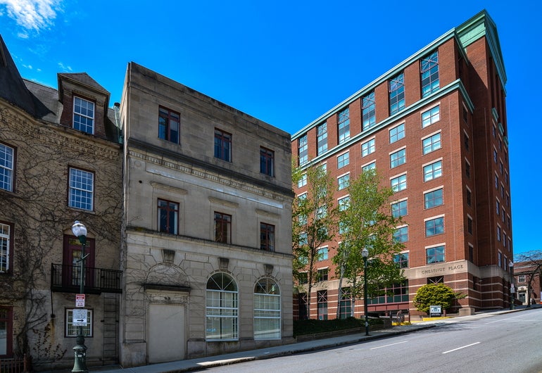 A three-story office building with a stucco/stone exterior
