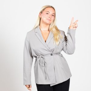 A blonde woman flashes the peace sign
