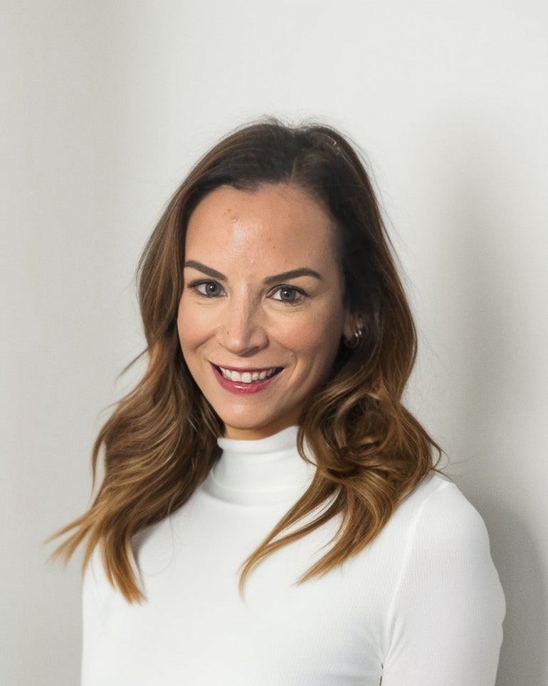 A woman wearing a white turtleneck