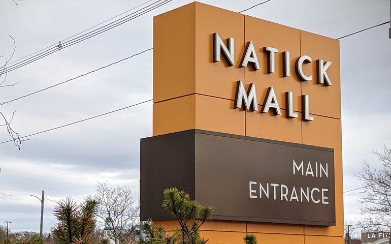 A large orange sign reads 
