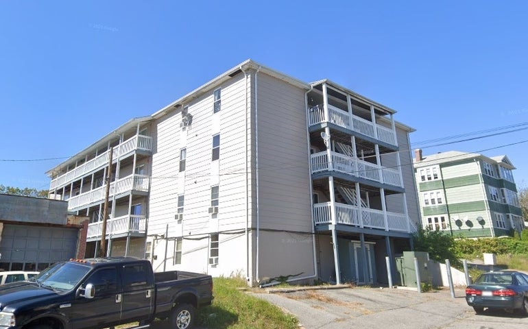 Four story gray apartment building