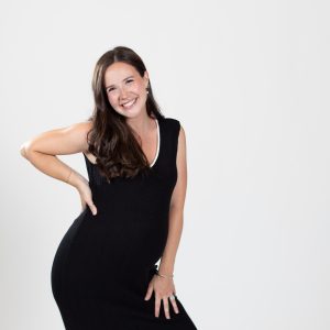 Woman wearing black dress smiles