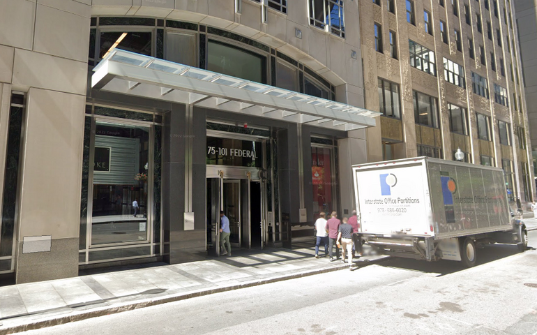The entrance of a large office building in an urban area