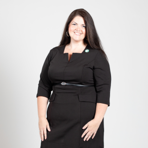 A woman with long brown hair wears a black dress.