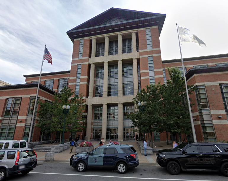 A large building with cars parked in front.