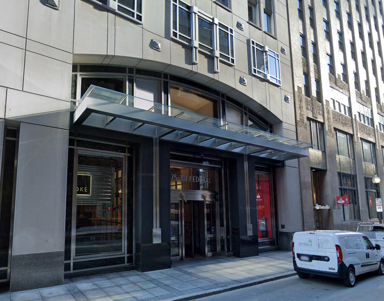 The entrance of a large office building in an urban area