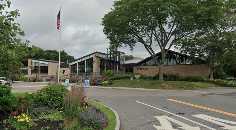 A one story building with a flagpole in front