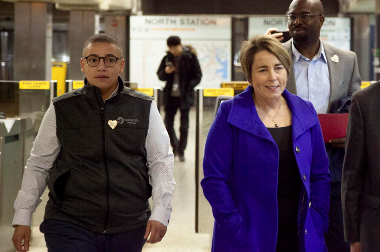 Two people standing in a subway station