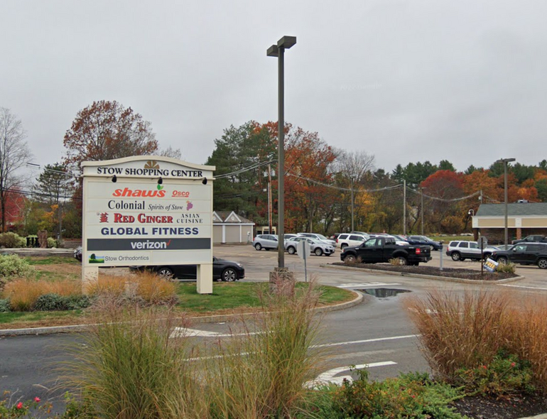 The sign for a shopping plaza featuring names of tenants