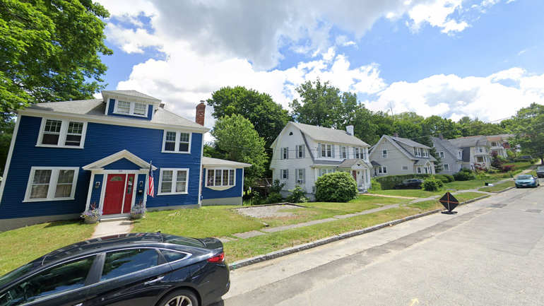 Three homes sit along a suburban street