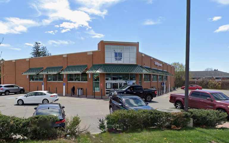 A brick, single-story, standalone pharmacy building