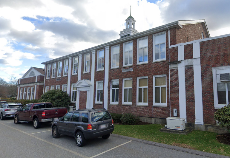 A two-story brick town hall building