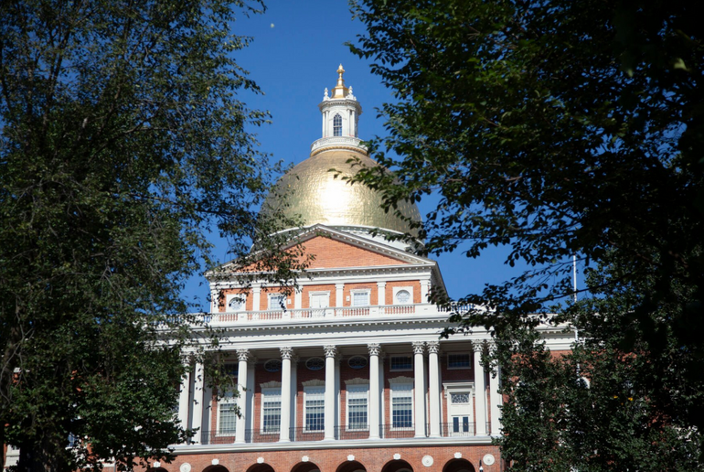 The golden dome and front of the Massachusetts State House seen from Boston Common