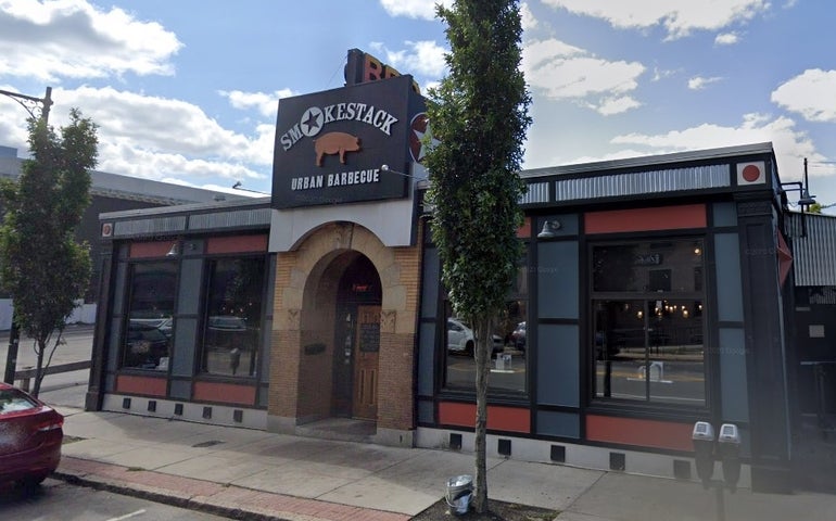 A small restaurant building with a sign above the door