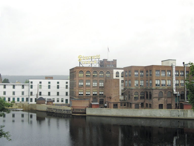 A large brick building with a yellow letters above reading 