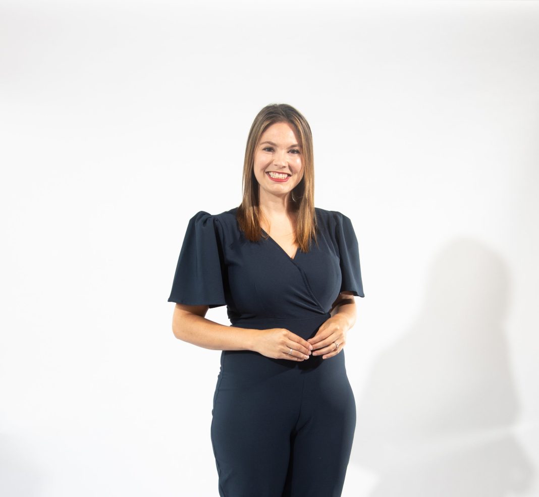 A woman in a dark blue pants suit