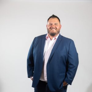 A man in a suit with his hands in his pockets