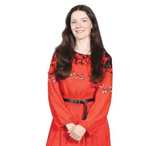 Woman in red dress smiles
