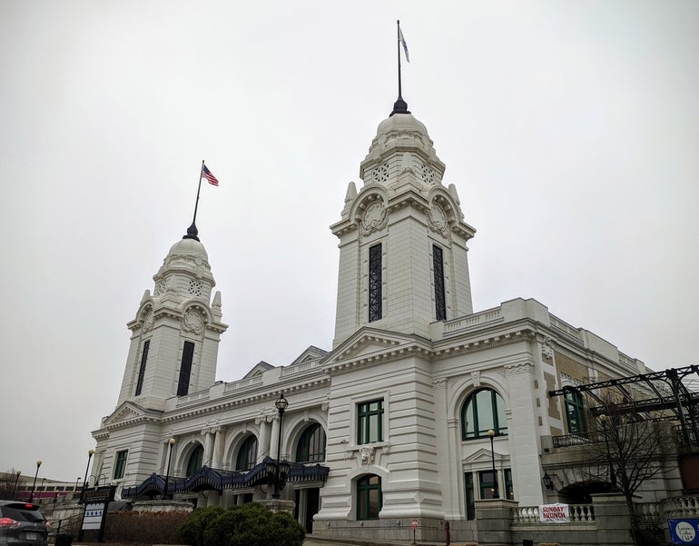A large white building with two spires.