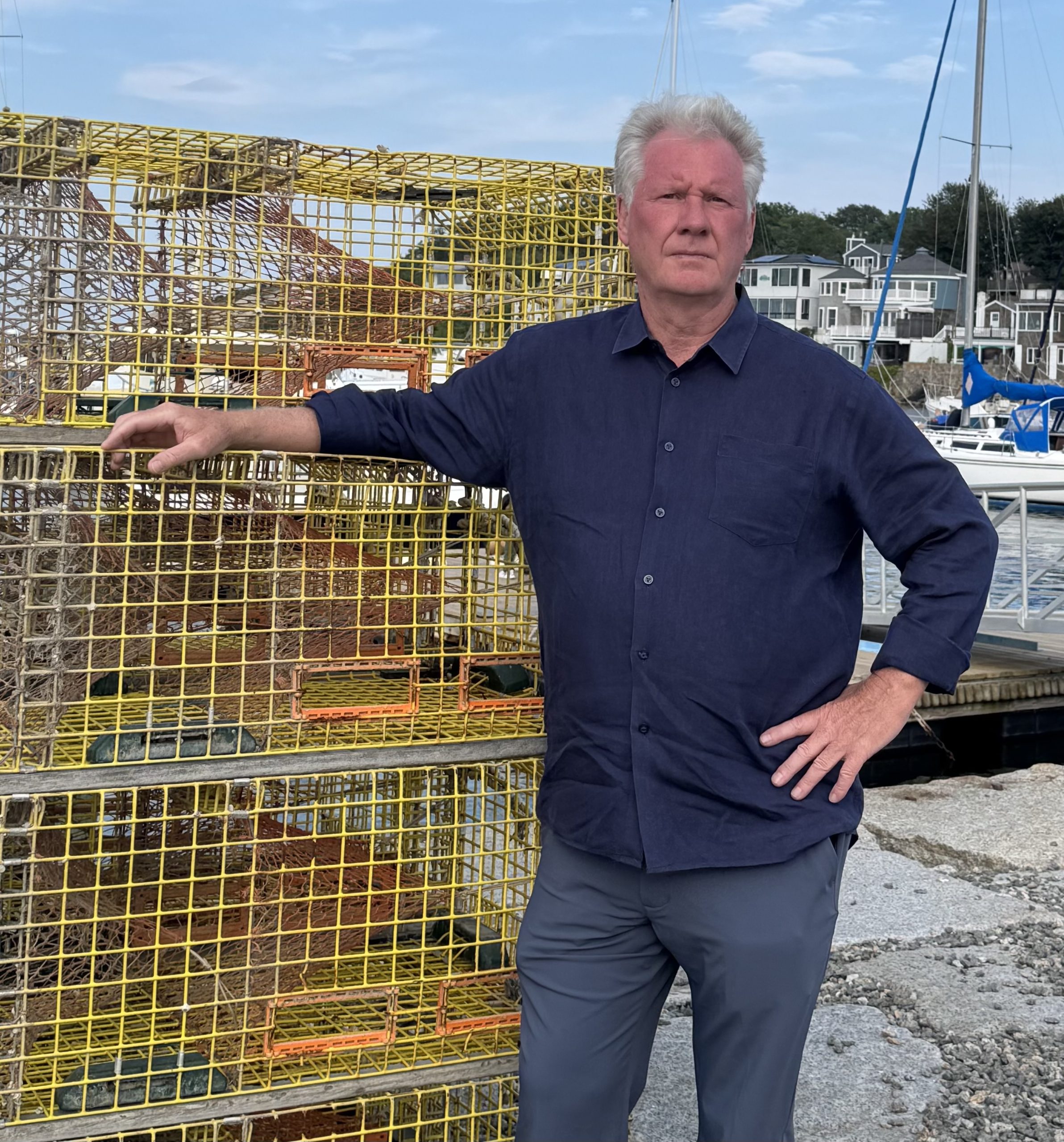 A man leans against lobster traps