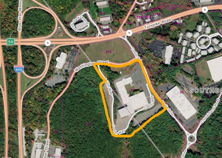 A satellite image with a parcel highlighted in orange