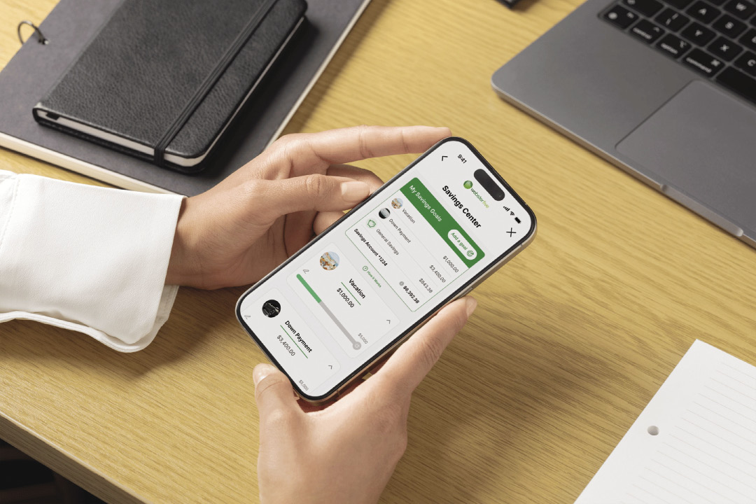 A smartphone being held over a desk.