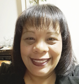 A woman with bangs smiles for the camera.