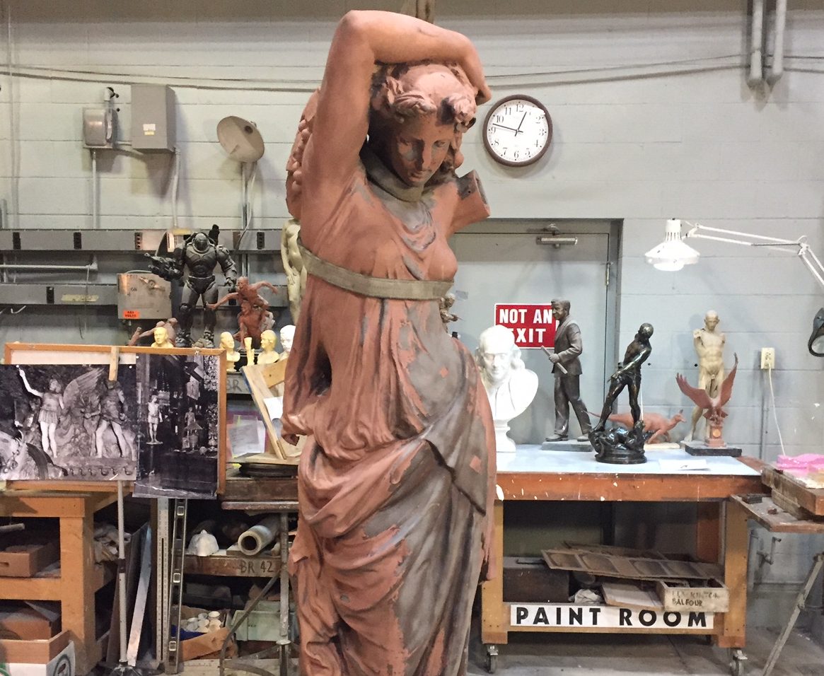 Rusty statue sits inside