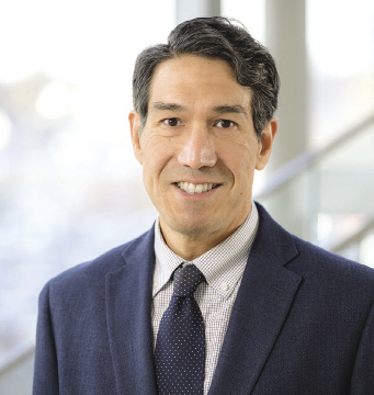 A man wears a dark blue suit.