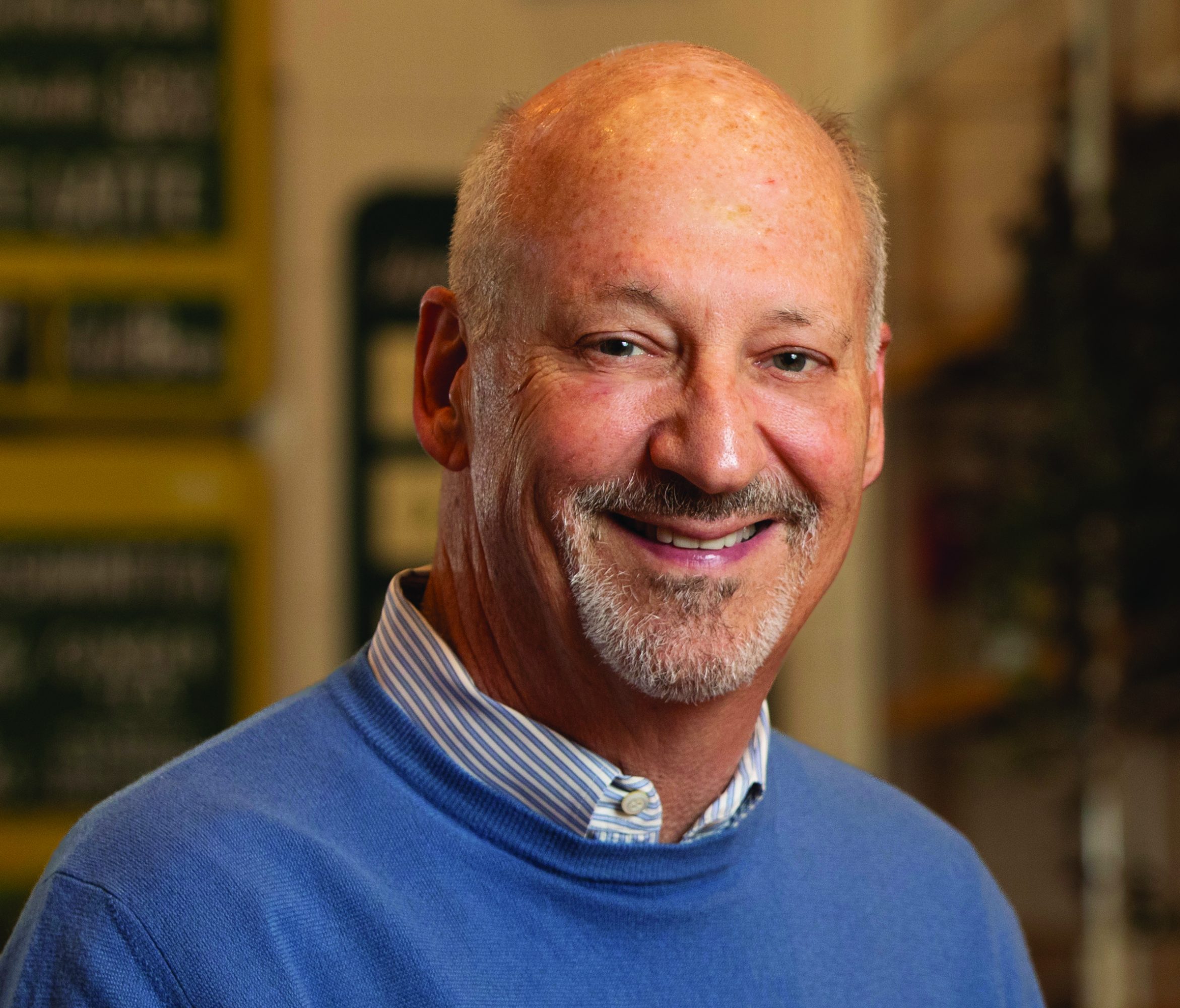 A man wears a blue sweater.