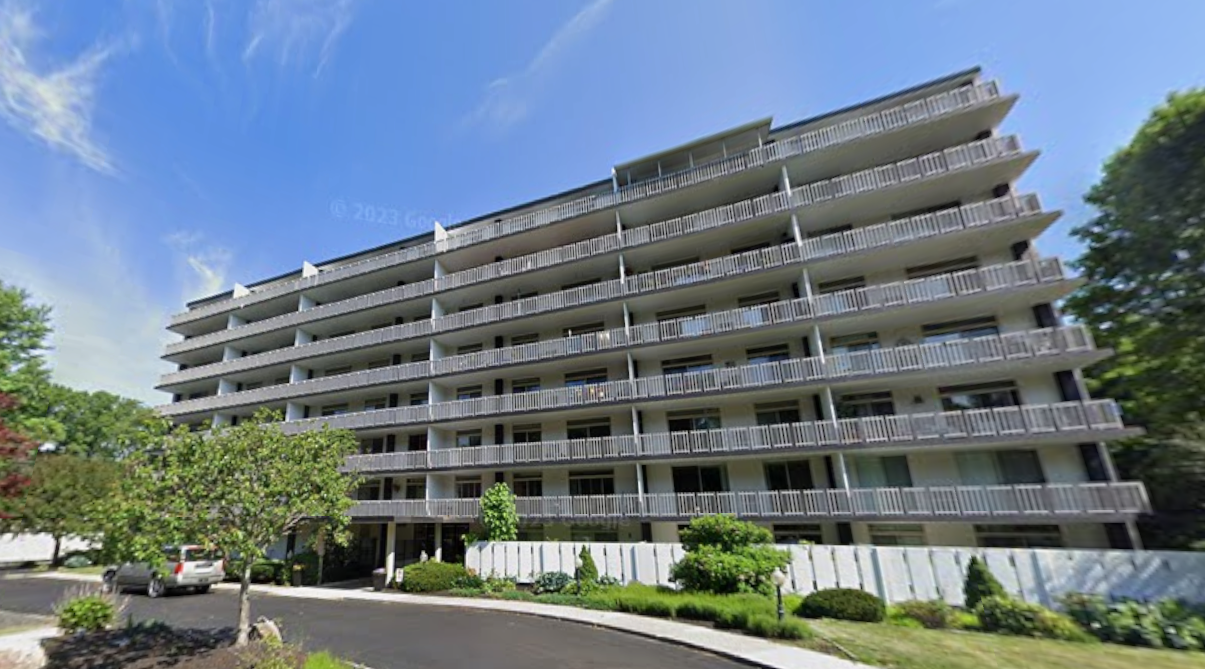 An eight-story apartment building with balconies