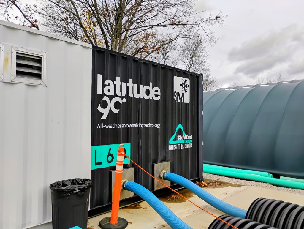 The outside of a  white shipping container designed to hold snowmaking equipment