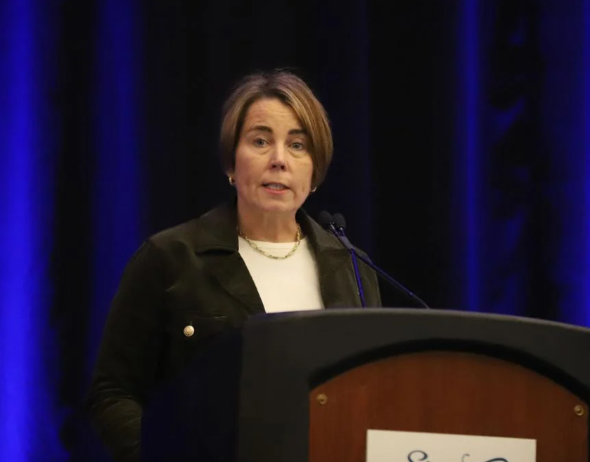 Woman in business attire speaks at podium
