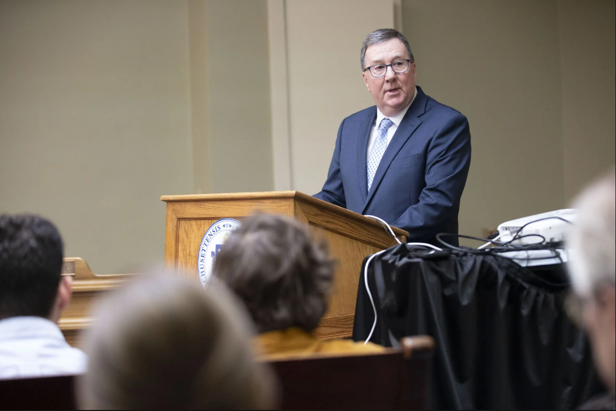 A man speaks at a podium