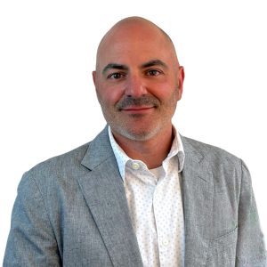 Man in grey suit smiles