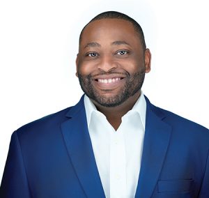 A man wears a royal blue blazer and a white button down.