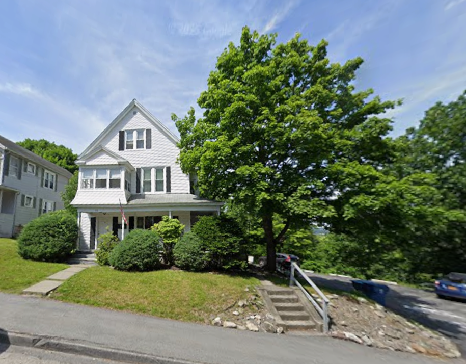 A two-and-a-half story, white house