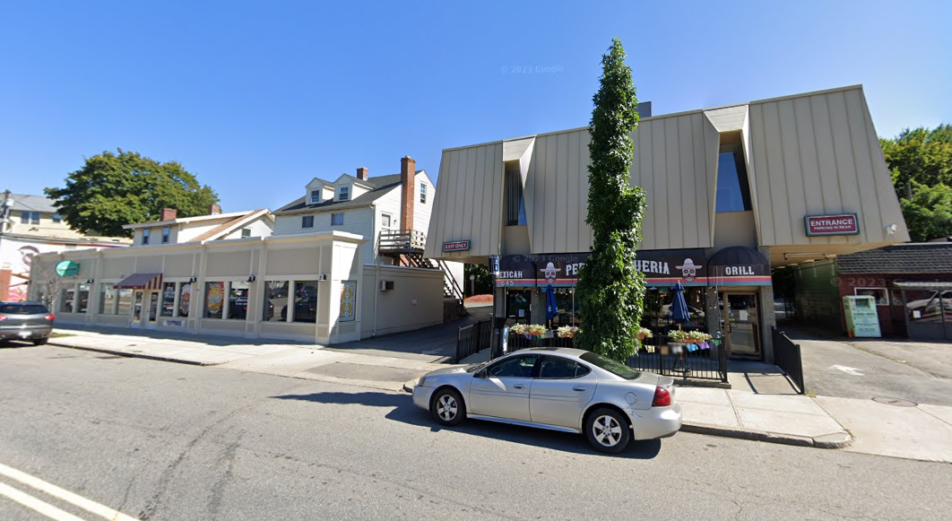 A two-story building and a one-story retail building