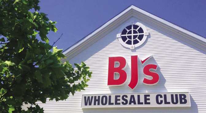 Outside a white building with a BJ's Wholesale Club sign
