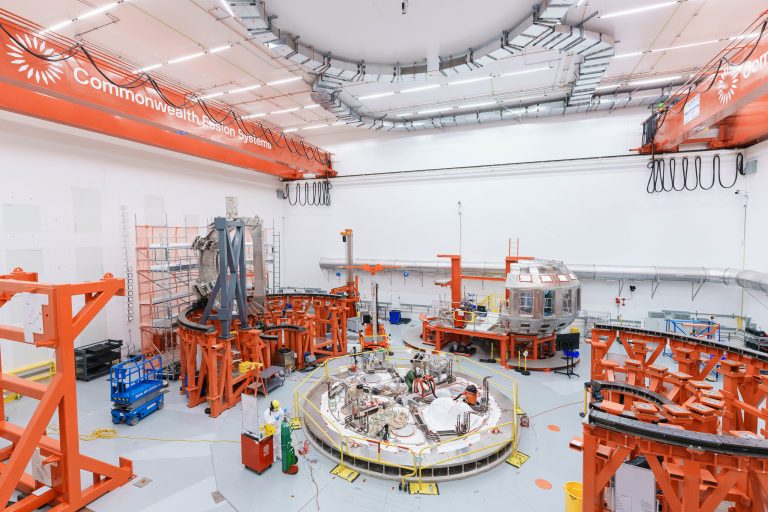 A large white room with orange mechanical equipment